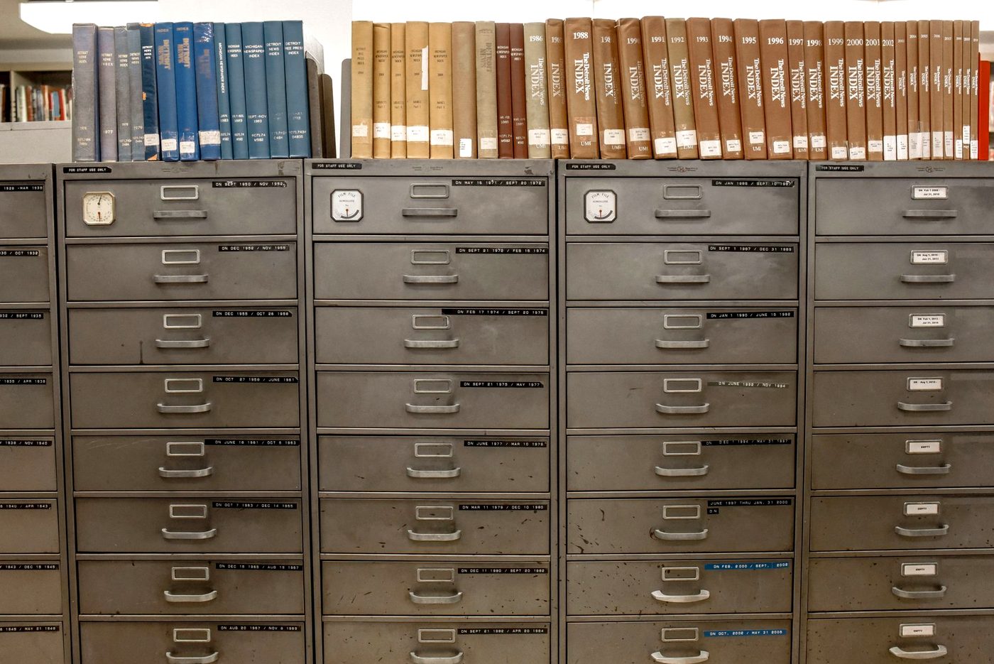 A bank of metal filing cabinets with labelled drawers.