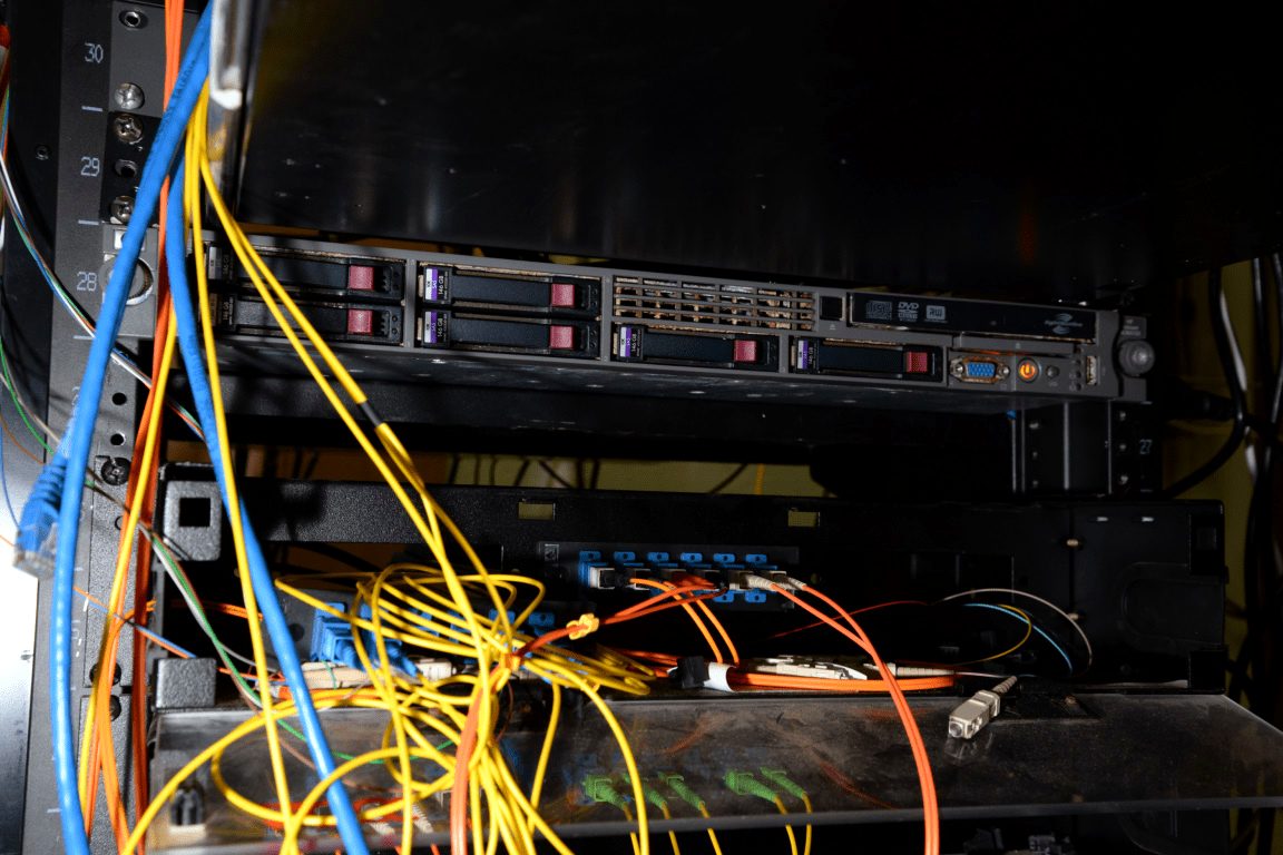 A floor-standing server rack packed with cabled equipment.