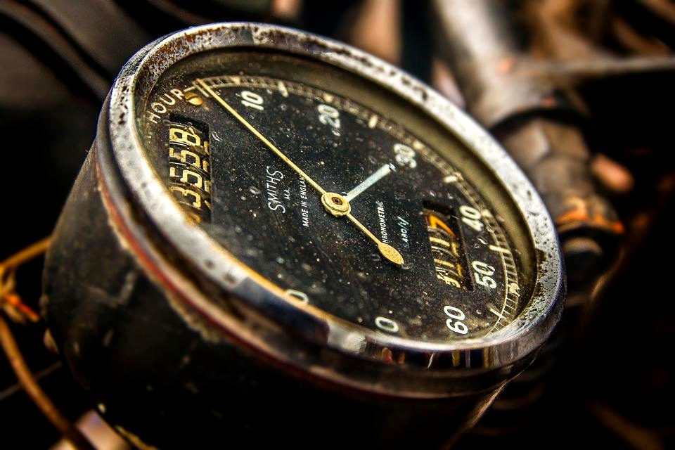 A mechanical stopwatch held with its second hand in motion.