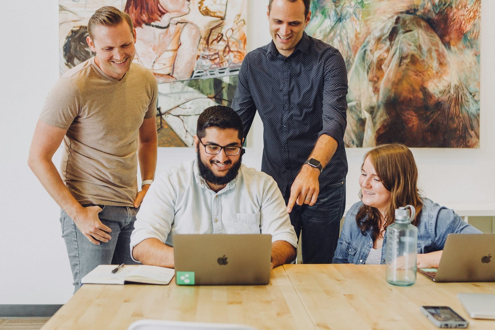 Agency creative team reviewing deliverables and milestone approvals with a client.