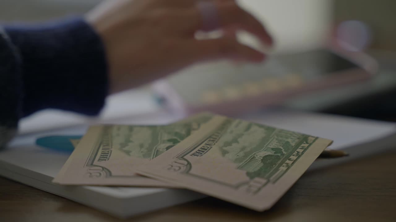 Financial documents and ledgers laid out on a desk: Pactbound seals every client-books handoff with an identity-verified acknowledgment.
